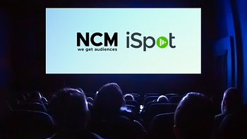NCM and iSpot logos on the big screen in front of an audience